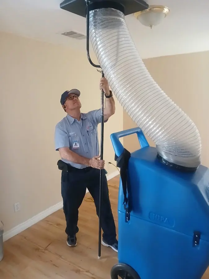 Furnace Tune-Up technician using HEPA equipment in Austin